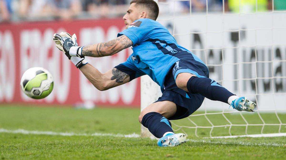 RODINGHAUSEN, GERMANY - AUGUST 11: Goalkeeper Jannik Huth of Paderborn saves a penalty of Lars Lokotsch of Roedinghausen during the DFB Cup first round match between SV Roedinghausen and SC Paderborn 07 at Kunstrasenplatz Haecker Wiehenstadion on August 11, 2019 in Rodinghausen, Germany. (Photo by Lars Baron/Bongarts/Getty Images)