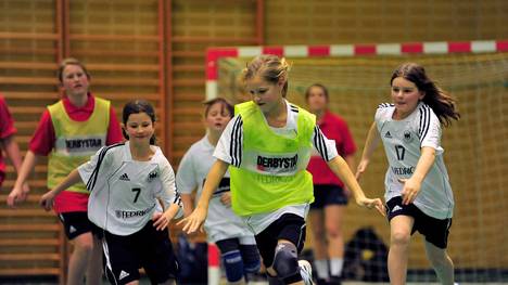 HAMBURG, GERMANY - FEBRUARY 05:  Action from handball game involving girls from local teams and Olympic athlets at an event where children meet Olympic competitors at the Hamburg Mannheimer headquarters on February 5, 2009 in Hamburg, Germany.  (Photo by Stuart Franklin/Bongarts/Getty Images)