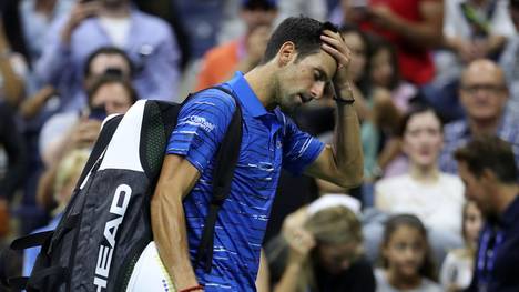 NEW YORK, NEW YORK - SEPTEMBER 01: Novak Djokovic of Serbia reacts as he walks off court after retiring due to a shoulder injury during his Men's Singles fourth round match against Stan Wawrinka of Switzerland on day seven of the 2019 US Open at the USTA Billie Jean King National Tennis Center on September 01, 2019 in Queens borough of New York City. (Photo by Matthew Stockman/Getty Images)
