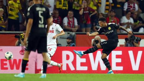 COLOGNE, GERMANY - AUGUST 23:  Jadon Sancho of Borussia Dortmund scores his side's first goal during the Bundesliga match between 1. FC Koeln and Borussia Dortmund at RheinEnergieStadion on August 23, 2019 in Cologne, Germany. (Photo by Lars Baron/Bongarts/Getty Images)