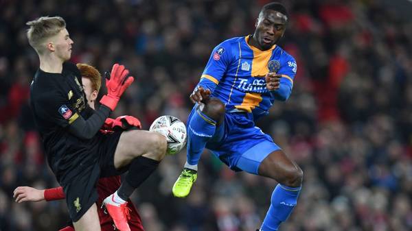 Shrewsbury Town's Nigerian striker Daniel Udoh (R) vies with Liverpool's Irish goalkeeper Caoimhin Kelleher (L) during the English FA Cup fourth round reply football match between Liverpool and Shrewsbury Town at Anfield in Liverpool, north west England on February 4, 2020. (Photo by Paul ELLIS / AFP) / RESTRICTED TO EDITORIAL USE. No use with unauthorized audio, video, data, fixture lists, club/league logos or 'live' services. Online in-match use limited to 120 images. An additional 40 images may be used in extra time. No video emulation. Social media in-match use limited to 120 images. An additional 40 images may be used in extra time. No use in betting publications, games or single club/league/player publications. /  (Photo by PAUL ELLIS/AFP via Getty Images)