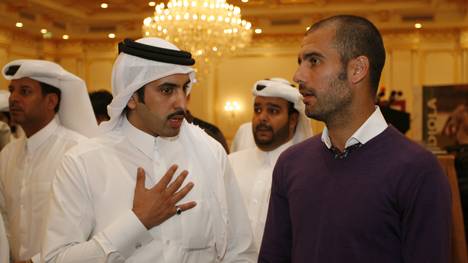 Barcelona coach Pep Guardiola (R) talks, Sheikh Ahmed bin Hamad Al-Thani 