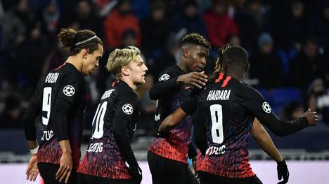 RB Leipzig's Swedish midfielder Emil Forsberg (2ndL) is congratulated by teammates after scoring a goal during the UEFA Champions League group G football match between Olympique Lyonnais (OL) and RB Leipzig, on December 10, 2019 at the Parc Olympique Lyonnais stadium in Decines-Charpieu near Lyon. (Photo by JEFF PACHOUD / AFP) (Photo by JEFF PACHOUD/AFP via Getty Images)