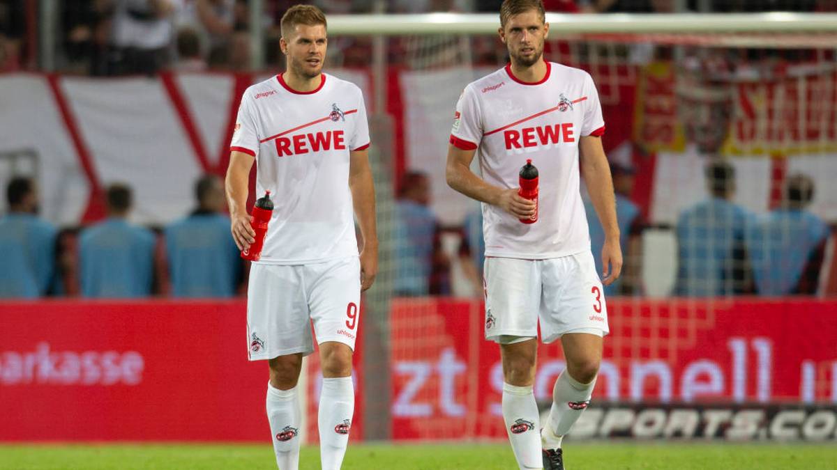 COLOGNE, GERMANY - AUGUST 13: Simon Terodde of Cologne (L) and Lasse Sobiech leave the pitch after the Second Bundesliga match between 1. FC Koeln and 1. FC Union Berlin at RheinEnergieStadion on August 13, 2018 in Cologne, Germany. (Photo by Juergen Schwarz/Bongarts/Getty Images)