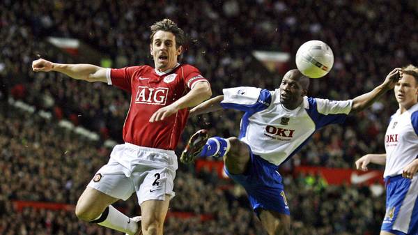 Manchester United's Gary Neville (L) vies with   Portsmouth's Bisan Lauren  during their FA Cup fourth round football match at Old Trafford , Manchester, North-west  England, 27 January , 2007. AFP PHOTO/ANDREW YATES (Photo by Andrew YATES / AFP) (Photo by ANDREW YATES/AFP via Getty Images)
