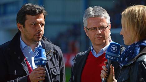 BIELEFELD, GERMANY - MAY 02: Sports directors Samir Arabi (L) of Bielefeld and Ralf Heskamp (C) of Kiel are being interviewed during the Third League match between Arminia Bielefeld and Holstein Kiel at Schueco Arena on May 2, 2015 in Bielefeld, Germany.  (Photo by Thomas Starke/Bongarts/Getty Images)