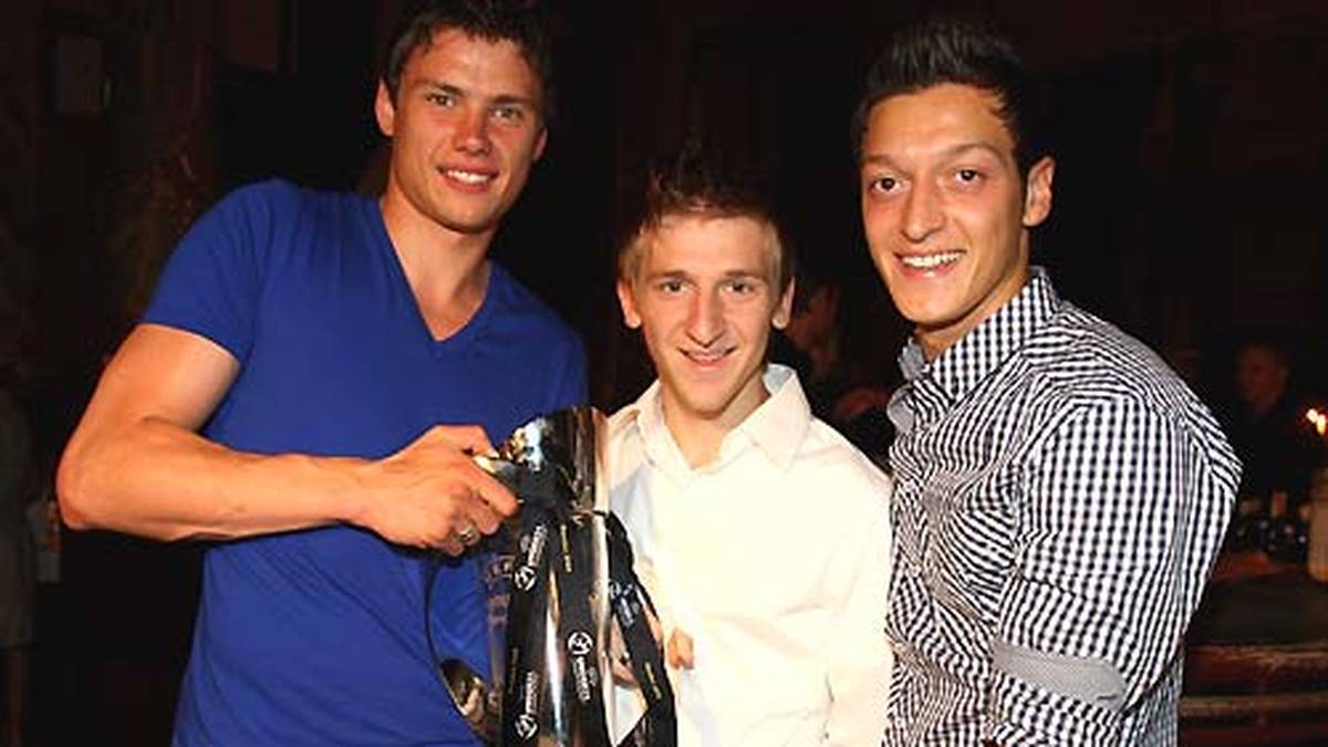 Mit den Bremer Teamkollegen Sebastian Boenisch (l.) und Marko Marin (M.) präsentiert Özil die Trophäe