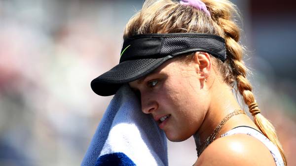 NEW YORK, NEW YORK - AUGUST 26: Eugenie Bouchard of Canada dries her face as she takes on Anastasija Sevastova (not pictured) of Latvia during their Women's Singles first round match during day one of the 2019 US Open at the USTA Billie Jean King National Tennis Center on August 26, 2019 in the Flushing neighborhood of the Queens borough of New York City.  (Photo by Clive Brunskill/Getty Images)