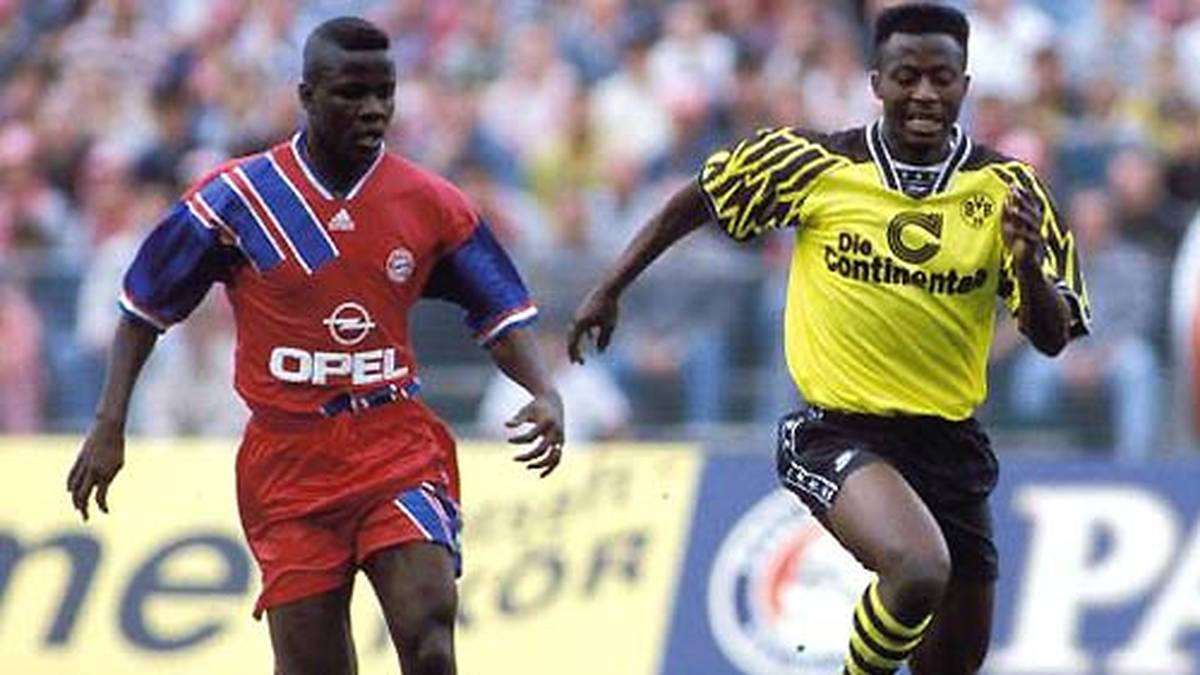 PLATZ 4 - IBRAHIM TANKO: Auf der Liste der jüngsten Spieler liegt Tanko (r.) mit 17 Jahren, 1 Monat und 30 Tagen auf Rang vier. Dafür ist der in Ghana geborene Stürmer der jüngste Meisterspieler seit Einführung der Bundesliga. Gleich in seiner ersten Saison 1994/1995 holt er mit dem BVB den Titel