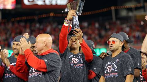 WASHINGTON, DC - OCTOBER 15: Juan Soto #22 of the Washington Nationals celebrates with the NLCS Trophy after winning the NL pennant with a 7-4 win in Game 4 of the NLCS against the St. Louis Cardinals at Nationals Park on Tuesday, October 15, 2019 in Washington, District of Columbia. (Photo by Alex Trautwig/MLB Photos via Getty Images)