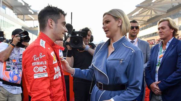 Ferrari's Monegasque driver Charles Leclerc (L) greets Princess Charlene of Monaco at the Yas Marina Circuit in Abu Dhabi, ahead of the final race of the season, on December 1, 2019. (Photo by ANDREJ ISAKOVIC / AFP) (Photo by ANDREJ ISAKOVIC/AFP via Getty Images)