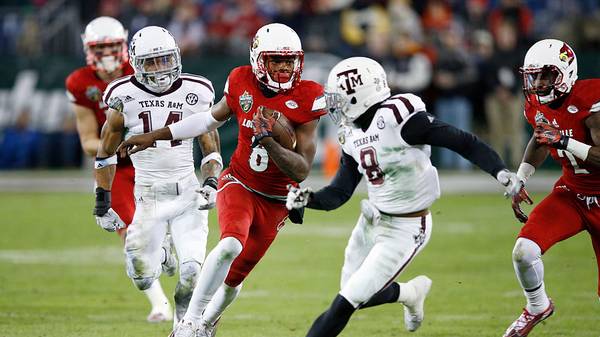Lamar Jackson #8 of the Louisville Cardinals runs the ball against the Texas A&M Aggies in the second half of the Franklin American Mortgage Music City Bowl