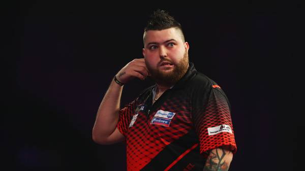 LONDON, ENGLAND - DECEMBER 23:  Michael Smith of England in action during the secod round match against Rob Cross of England on day ten of the 2018 William Hill PDC World Darts Championships at Alexandra Palace on December 23, 2017 in London, England.  (Photo by Naomi Baker/Getty Images)