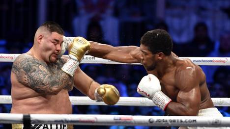British boxer Anthony Joshua (white trunks) competes with Mexican-American boxer Andy Ruiz Jr (golden trunks) during the heavyweight boxing match between Andy Ruiz Jr. and Anthony Joshua for the IBF, WBA, WBO and IBO titles in Diriya, near the Saudi capital on December 7, 2019. - Ruiz seeks to win back the titles that he lost to Ruiz in a shock June defeat in New York in this high-profile duel , dubbed "Clash on the Dunes". (Photo by Fayez Nureldine / AFP) (Photo by FAYEZ NURELDINE/AFP via Getty Images)