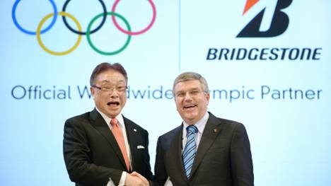 Vergangenheit: Firmenchef Tsuya (l.) und IOC-Boss Bach