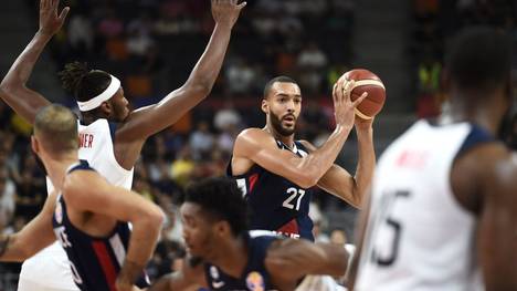 France's Rudy Gobert holds the ball as Myles Turner (L) of the US tries to block during the Basketball World Cup quarter-final game between US and France in Dongguan on September 11, 2019. (Photo by Ye Aung Thu / AFP)        (Photo credit should read YE AUNG THU/AFP/Getty Images)