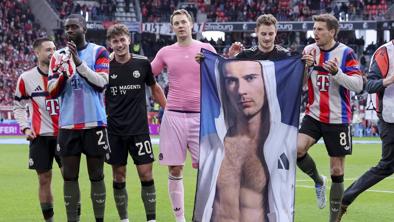 Josip Stanisic hält ein Plakat, auf dem Leon Goretzka zu sehen ist