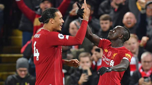 Liverpool's Senegalese striker Sadio Mane (R) celebrates with Liverpool's Dutch defender Virgil van Dijk (L) after scoring their third goal during the English Premier League football match between Liverpool and Manchester City at Anfield in Liverpool, north west England on November 10, 2019. (Photo by Paul ELLIS / AFP) / RESTRICTED TO EDITORIAL USE. No use with unauthorized audio, video, data, fixture lists, club/league logos or 'live' services. Online in-match use limited to 120 images. An additional 40 images may be used in extra time. No video emulation. Social media in-match use limited to 120 images. An additional 40 images may be used in extra time. No use in betting publications, games or single club/league/player publications. /  (Photo by PAUL ELLIS/AFP via Getty Images)