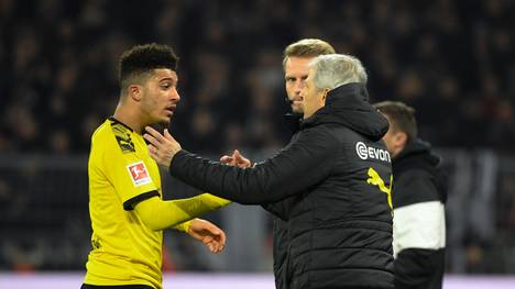 Dortmund's English forward Jadon Sancho and Dortmund's Swiss coach Lucien Favre (R) speak on the sideline during the German first division Bundesliga football match BVB Borussia Dortmund vs Eintracht Frankfurt, in Dortmund, western Germany on February 14, 2020. (Photo by INA FASSBENDER / AFP) / RESTRICTIONS: DFL REGULATIONS PROHIBIT ANY USE OF PHOTOGRAPHS AS IMAGE SEQUENCES AND/OR QUASI-VIDEO (Photo by INA FASSBENDER/AFP via Getty Images)