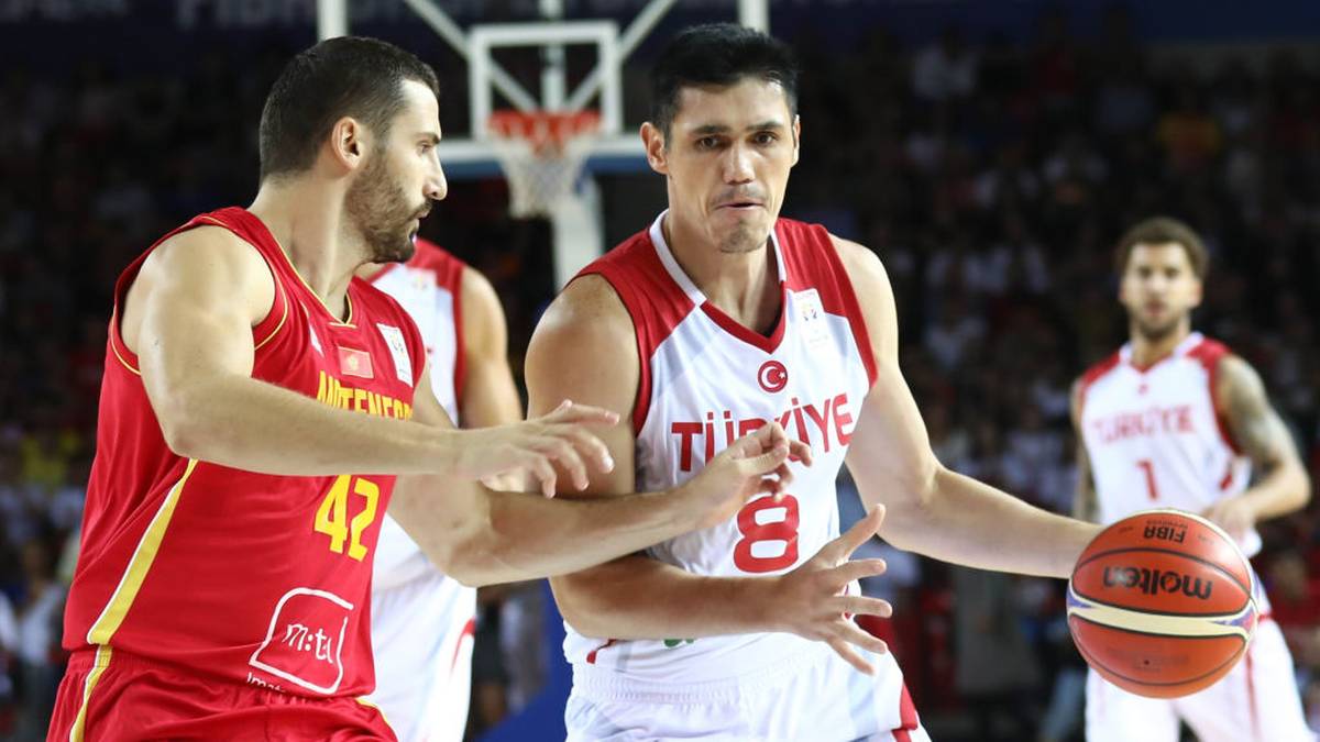Turkey's forward Ersan Ilyasova (C) fights for the ball with Montenegro's forward Nemanja Djurisic (L)during the 2019 FIBA Basketball World Championship European qualifying group match between Turkey and Montenegro at The Ankara Sports Hall in Ankara on September 14, 2018. (Photo by ADEM ALTAN / AFP)        (Photo credit should read ADEM ALTAN/AFP/Getty Images)