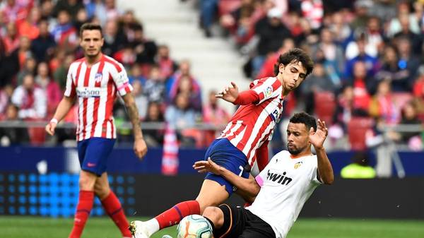 Atletico Madrid's Portuguese forward Joao Felix (R) vies with Valencia's French midfielder Francis Coquelin during the Spanish league football match Club Atletico de Madrid against Valencia CF at the Wanda Metropolitano stadium in Madrid on October 19, 2019. (Photo by PIERRE-PHILIPPE MARCOU / AFP) (Photo by PIERRE-PHILIPPE MARCOU/AFP via Getty Images)