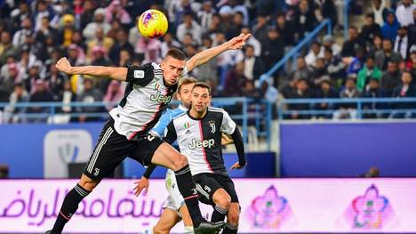 Juventus' Turkish defender Merih Demiral (L) heads the ball during the Supercoppa Italiana final football match between Juventus and Lazio at the King Saud University Stadium in the Saudi capital Riyadh on December 22, 2019. (Photo by GIUSEPPE CACACE / AFP) (Photo by GIUSEPPE CACACE/AFP via Getty Images)