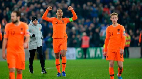 Netherlands' defender Virgil van Dijk (C) celebrates their qualification for the finals on the pitch after the Euro 2020 qualification football match between Northern Ireland and Netherlands at Windsor Park in Belfast on November 16, 2019. (Photo by Mark MARLOW / AFP) (Photo by MARK MARLOW/AFP via Getty Images)