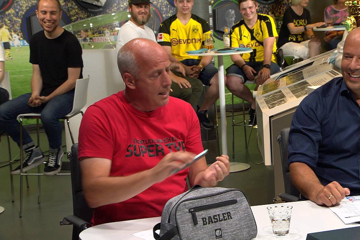 Mit Aspirin, Nagelfeile und Gesichtscreme ausgestattet, sitzt SPORT1-Experte Mario Basler im Fantalk. Warum das so ist, erklärt er im Video.