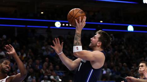 DALLAS, TEXAS - NOVEMBER 22:  Luka Doncic #77 of the Dallas Mavericks takes a shot against the Cleveland Cavaliers in the second half at American Airlines Center on November 22, 2019 in Dallas, Texas.  NOTE TO USER: User expressly acknowledges and agrees that, by downloading and or using this photograph, User is consenting to the terms and conditions of the Getty Images License Agreement.  (Photo by Ronald Martinez/Getty Images)