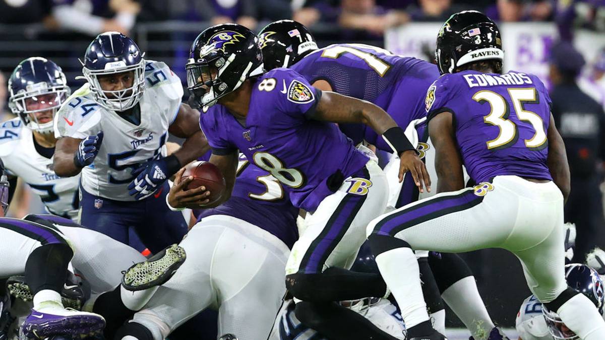 BALTIMORE, MARYLAND - JANUARY 11: Quarterback Lamar Jackson #8 of the Baltimore Ravens is stopped short by the Tennessee Titans defense on fourth down in the second half during the AFC Divisional Playoff game at M&T Bank Stadium on January 11, 2020 in Baltimore, Maryland. (Photo by Rob Carr/Getty Images)