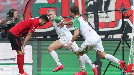AUGSBURG, GERMANY - FEBRUARY 15: Philipp Max (C) of FC Augsburg celebrates his first goal together with teammate Florian Niederlechner (R) during the Bundesliga match between FC Augsburg and Sport-Club Freiburg at WWK-Arena on February 15, 2020 in Augsburg, Germany. (Photo by Alexandra Beier/Bongarts/Getty Images)