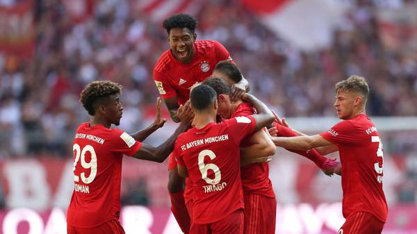 David Alaba (top) of FC Bayern Muenchen celebrates a goal during the Bundesliga match between FC Bayern Muenchen and 1. FSV Mainz 05 at Allianz Arena on August 31, 2019 in Munich, Germany. (Photo by Alexander Hassenstein/Bongarts/Getty Images)