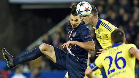 Zlatan Ibrahimovic (L) heads the ball with Chelsea's English defender Gary Cahill