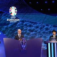 Die Lose für die Gruppen der EM 2024 werden nicht ganz ohne einen Lapsus gezogen. Ein UEFA-Mann prescht vor - und eine Losfee ist ratlos.