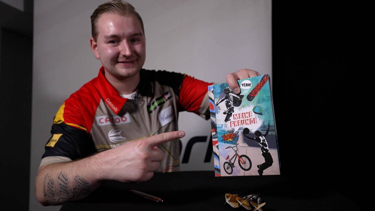 Darts WM 2023: Dimitri van den Bergh schreibt ins SPORT1-Freundschaftsbuch