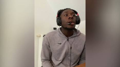 Bayern-Star Alphonso Davies fiebert trotz Verletzung eifrig mit. Beim Sieg in Salzburg zeigt er sich auf dem heimischen Sofa in Reporterlaune.