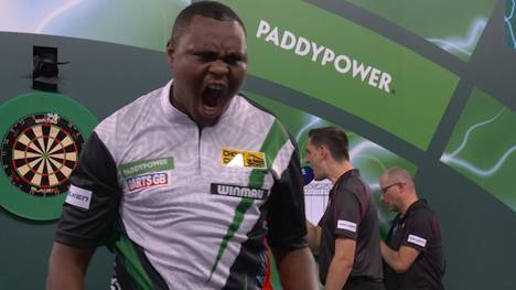 Der Kenianer David Munyua sorgt in der ersten Runde der Darts-WM 2026 für eine der größten Sensationen der WM-Geschichte. Er schlägt den Belgier Mike De Decker.