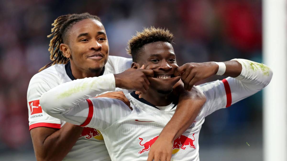 LEIPZIG, GERMANY - NOVEMBER 02: Nordi Mukiele of RB Leipzig celebrates  scoring his team's seventh goal with Christopher Nkunku  during the Bundesliga match between RB Leipzig and 1. FSV Mainz 05 at Red Bull Arena on November 02, 2019 in Leipzig, Germany. (Photo by Boris Streubel/Bongarts/Getty Images)