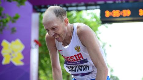 Russia's Sergey Kirdyapkin rests after c
