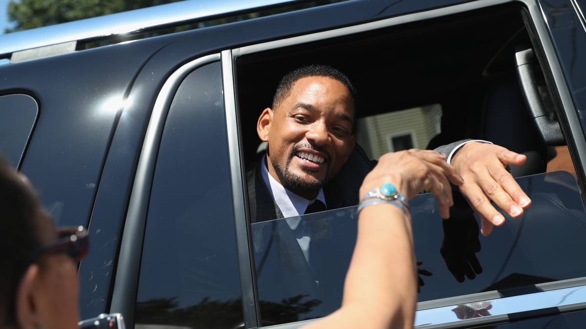 Sargträger Will Smith begrüßt einige Leute, die ein Spalier um den Leichenwagen gebildet haben