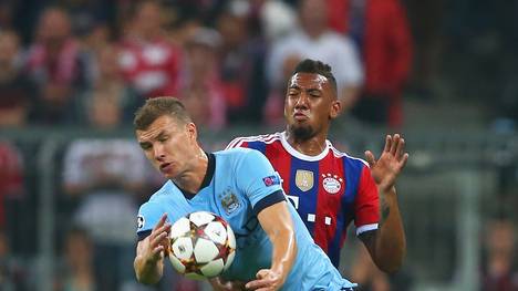 Edin Dzeko von Manchester City gegen Jerome Boateng vom FC Bayern Munchen