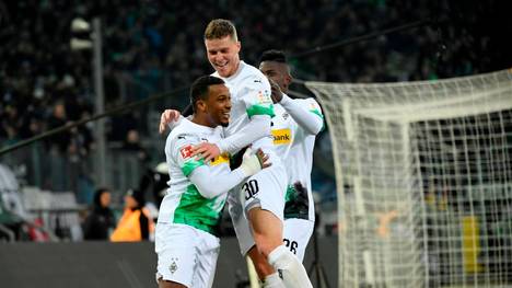 Moenchengladbach's Swiss forward Breel Embolo, French forward Alassane Plea and Moenchengladbach's Swiss defender Nico Elvedi celebrate a goal during during the German first division Bundesliga football match Borussia Moenchengladbach v Mainz 05 in Moenchengladbach on January 25, 2020. (Photo by INA FASSBENDER / AFP) / DFL REGULATIONS PROHIBIT ANY USE OF PHOTOGRAPHS AS IMAGE SEQUENCES AND/OR QUASI-VIDEO (Photo by INA FASSBENDER/AFP via Getty Images)