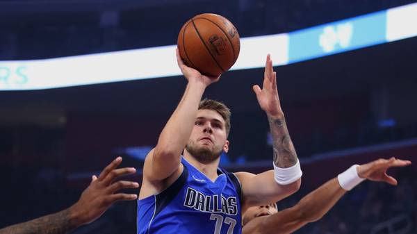 DETROIT, MICHIGAN - OCTOBER 09: Luka Doncic #77 of the Dallas Mavericks takes a first half shot in front of Bruce Brown #6 of the Detroit Pistons at Little Caesars Arena on October 09, 2019 in Detroit, Michigan.  NOTE TO USER: User expressly acknowledges and agrees that, by downloading and/or using this photograph, user is consenting to the terms and conditions of the Getty Images License Agreement. (Photo by Gregory Shamus/Getty Images)