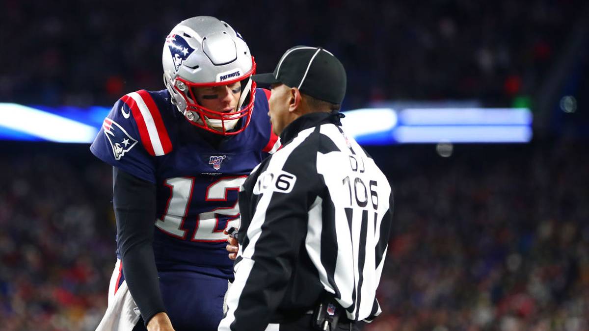 FOXBOROUGH, MASSACHUSETTS - DECEMBER 08: Tom Brady #12 of the New England Patriots argues a call with head linesman Wayne  Mackie during the fourth quarter of the game between the New England Patriots and the Kansas City Chiefs at Gillette Stadium on December 08, 2019 in Foxborough, Massachusetts. (Photo by Adam Glanzman/Getty Images)