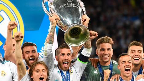 TOPSHOT - Real Madrid's Spanish defender Sergio Ramos lifts the trophy as Real Madrid players celebrate winning the UEFA Champions League final football match between Liverpool and Real Madrid at the Olympic Stadium in Kiev, Ukraine on May 26, 2018. - Real Madrid defeated Liverpool 3-1. (Photo by Paul ELLIS / AFP)        (Photo credit should read PAUL ELLIS/AFP/Getty Images)