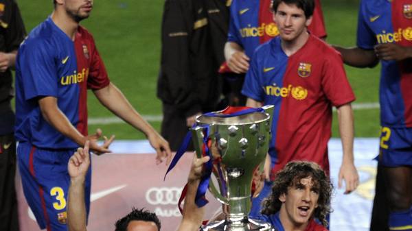 Barcelona's players Carles Puyol (R) and