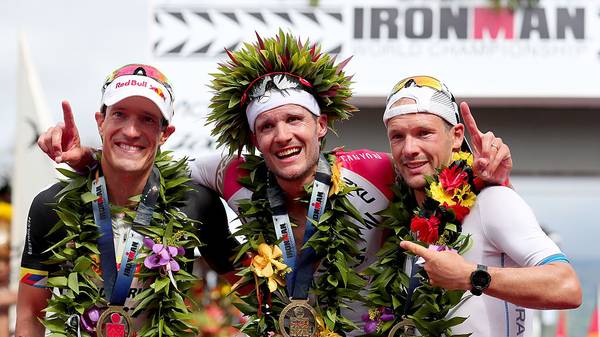 KAILUA KONA, HI - OCTOBER 08:  (L-R) Sebastian Kienle #2 of Germany, in second place, Jan Frodeno #1 of Germany, in first place, and Patrick Lange #20 of Germany, in third place, celebrates after finishing the 2016 IRONMAN World Championship triathlon on October 8, 2016 in Kailua Kona, Hawaii.  (Photo by Tom Pennington/Getty Images for Ironman)