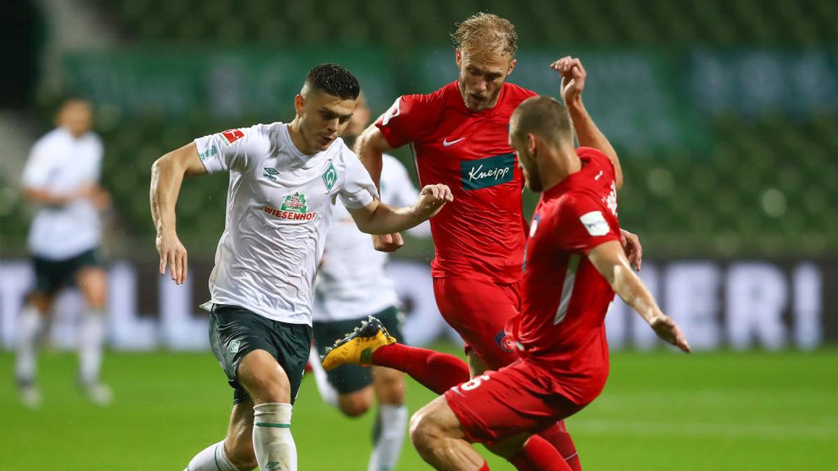BREMEN, GERMANY - JULY 02: Milot Rashica of Bremen is challenged by Timo Beermann and Patrick Mainka of Heidenheim during the Bundesliga playoff first leg match between Werder Bremen and 1. FC Heidenheim at Wohninvest Weserstadion on July 02, 2020 in Bremen, Germany. (Photo by Martin Rose/Bongarts/Getty Images)