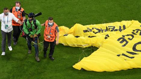 Es war der Aufreger beim gestrigen EM-Auftaktspiel: Ein Paraglider sorgte in München für einen Schockmoment. Jetzt erklärt die Polizei, welche Anklage dem Greenpeace-Aktivisten droht.