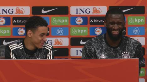 Eine Ton-Panne auf der Pressekonferenz nach dem 1:1 gegen die Niederlande lässt die DFB-Stars Antonio Rüdiger und Jamal Musiala in Gelächter ausbrechen.